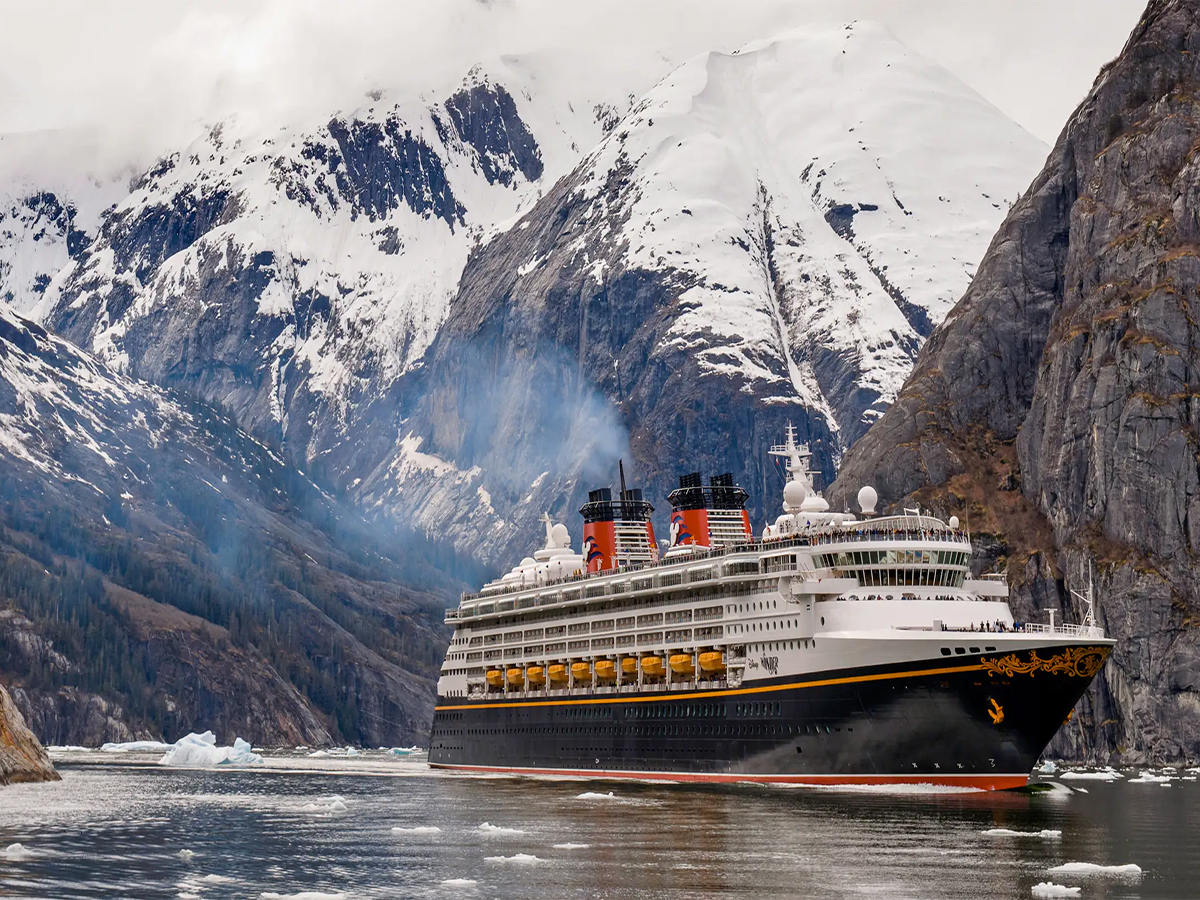 Disney Cruise Line ship sailing past mountains on an Alaska cruise from Vancouver