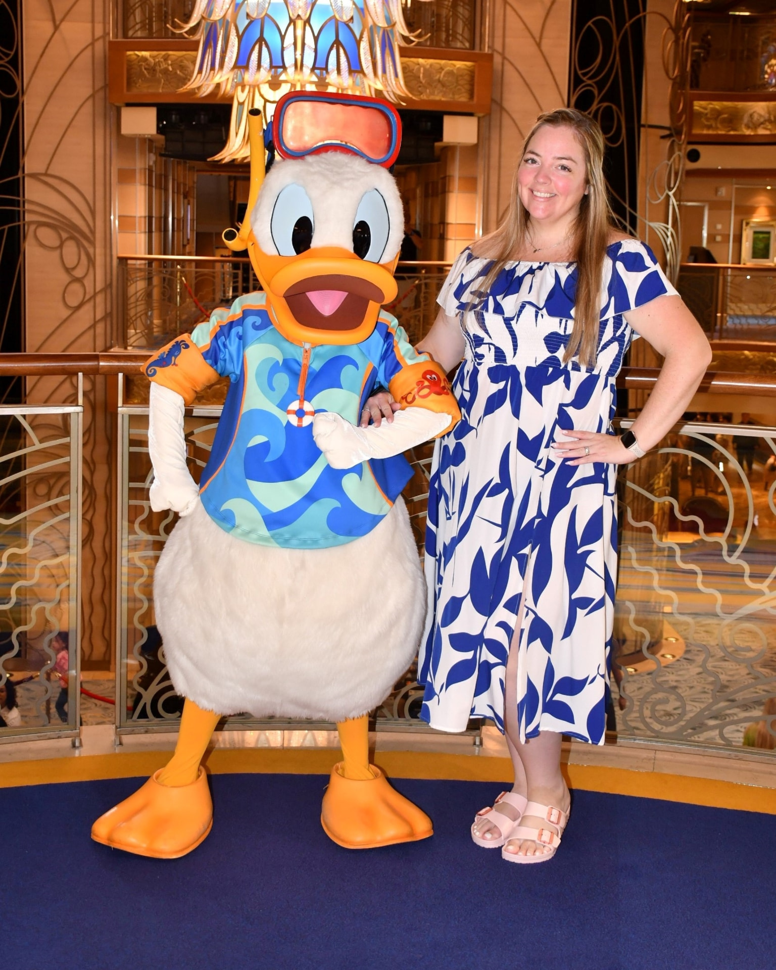 Sarah Field with Donald Duck in the atrium of a Disney Cruise Line ship