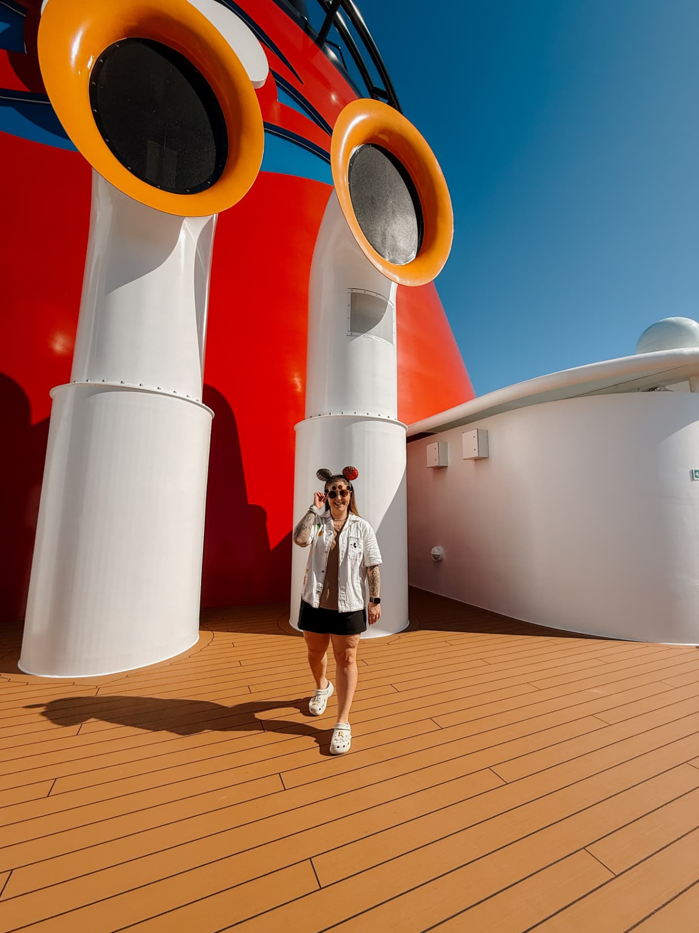 Jenna Caron on the deck of a Disney cruise ship by the funnels
