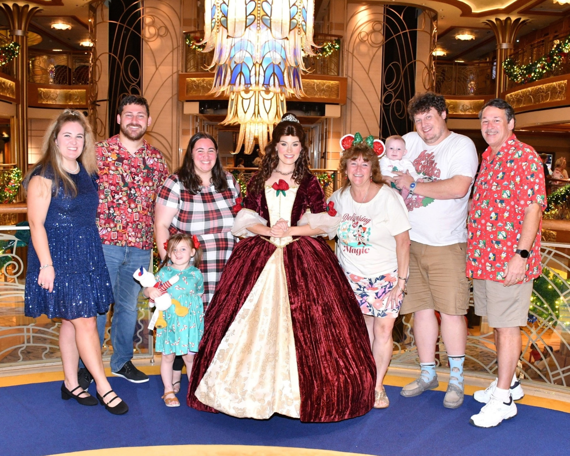 Faith Colletti and her family with Belle in the atrium of a Disney Cruise Line ship