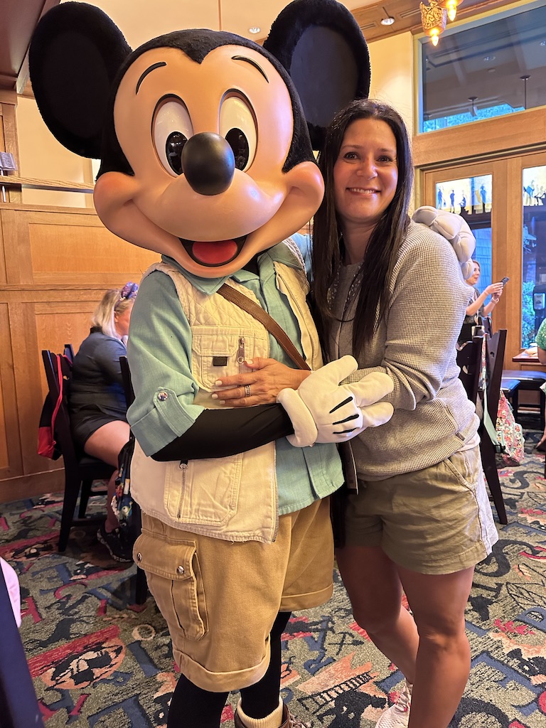 Deborah hugging Mickey Mouse
