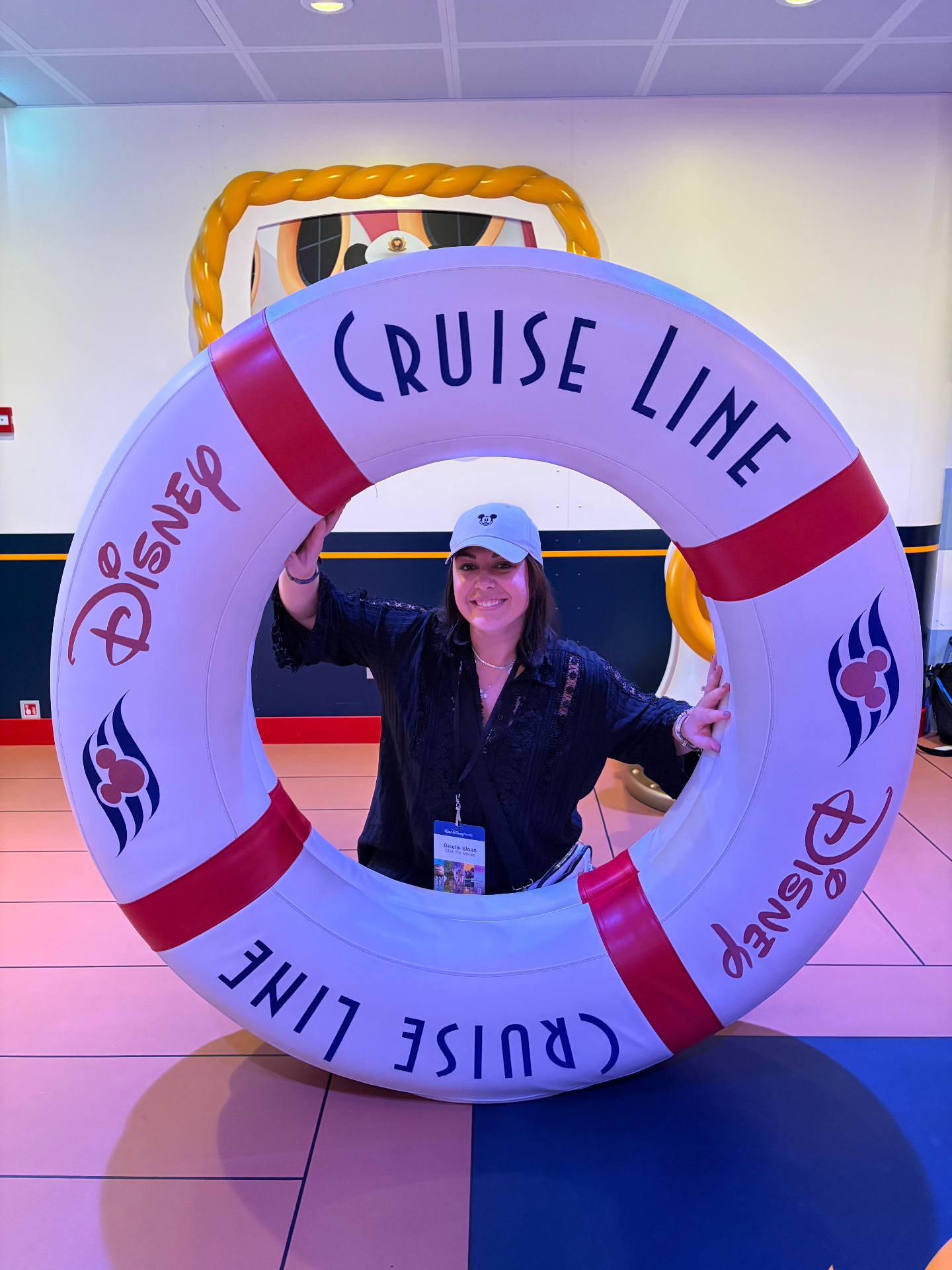 Giselle inside a giant Disney Cruise Line life ring on the Disney Dream