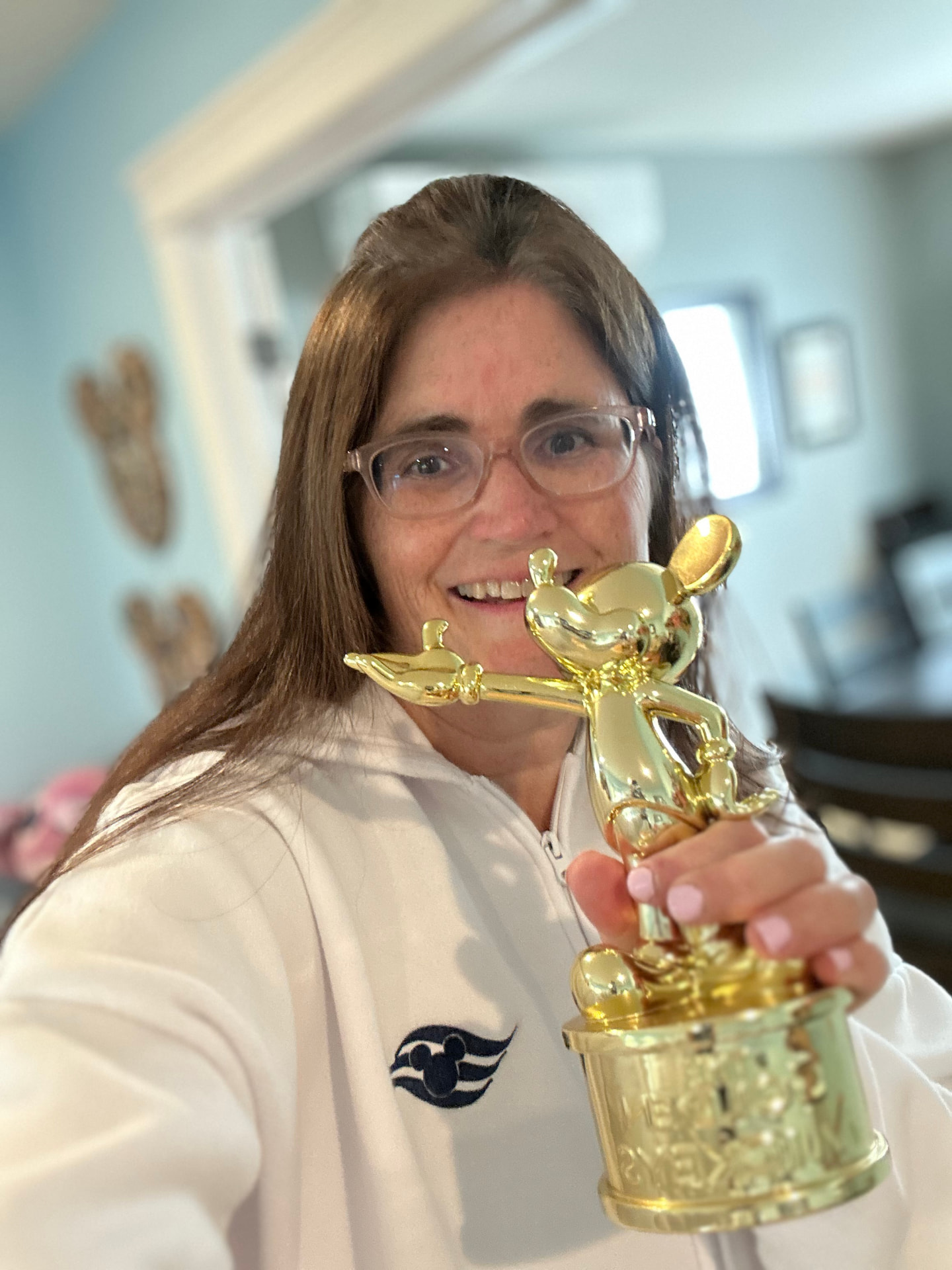 Amy Wear with a golden Mickey trophy