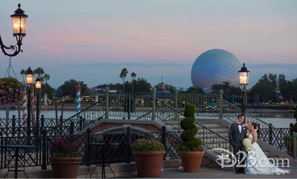 Laura and her husband in wedding attire beside World Showcase Lagoon with Spaceship Earth in the distance