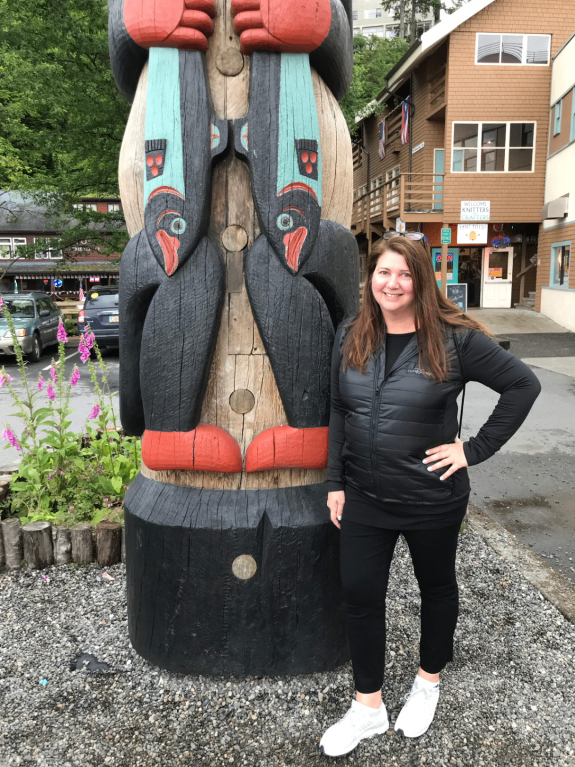 Sandra beside a totem pole in Alaska during a Disney Cruise from Vancouver