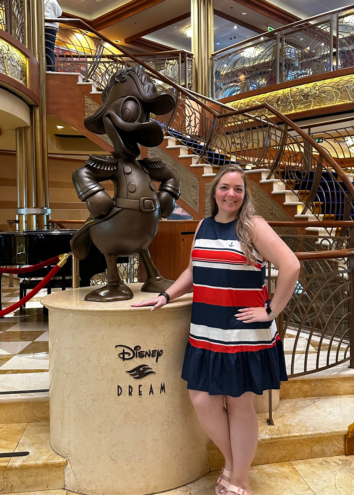 Sarah Field with the Captain Donald statue in the atrium of the Disney Dream