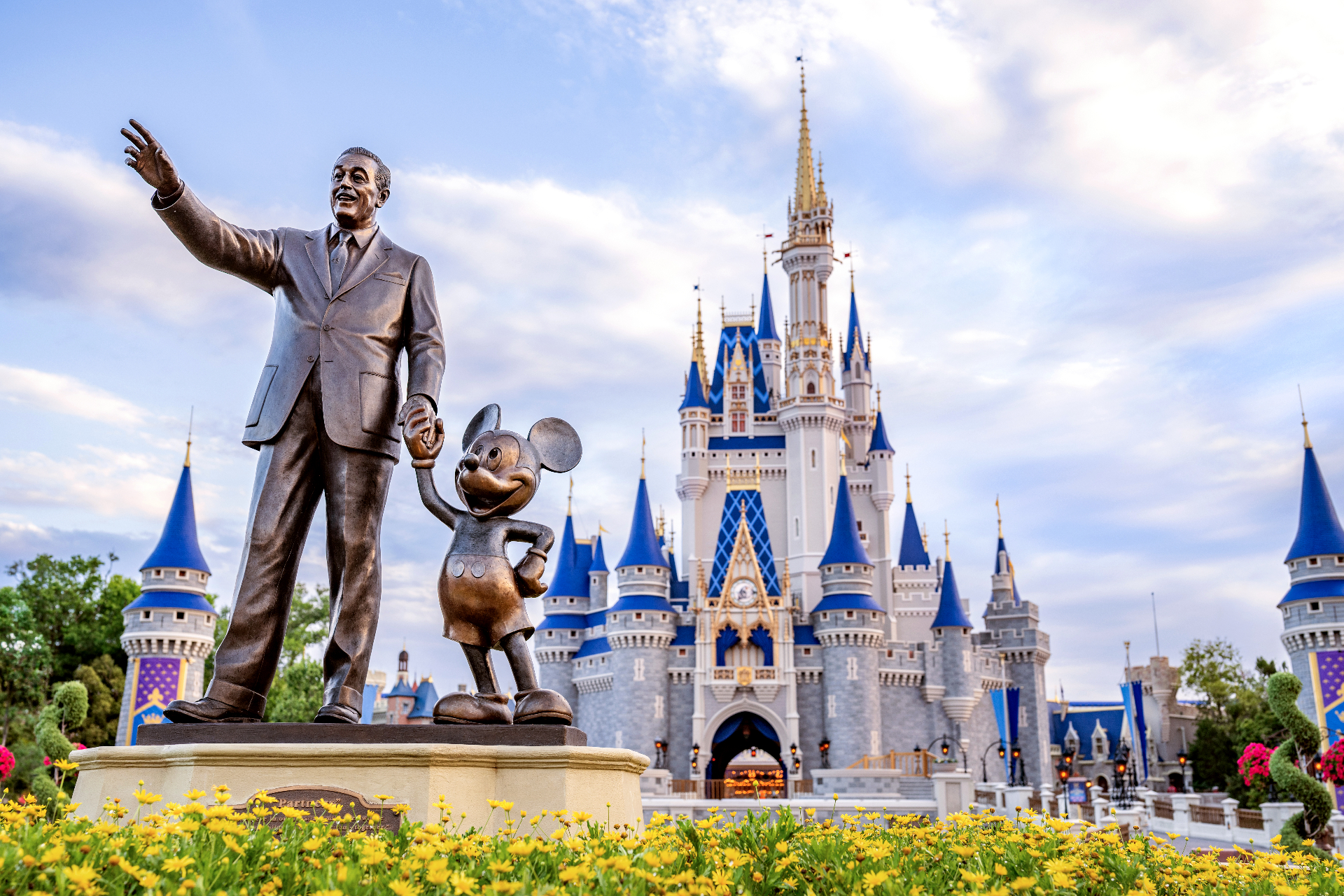 Walt Disney and Mickey Mouse Partners statue with Cinderella Castle at Magic Kingdom