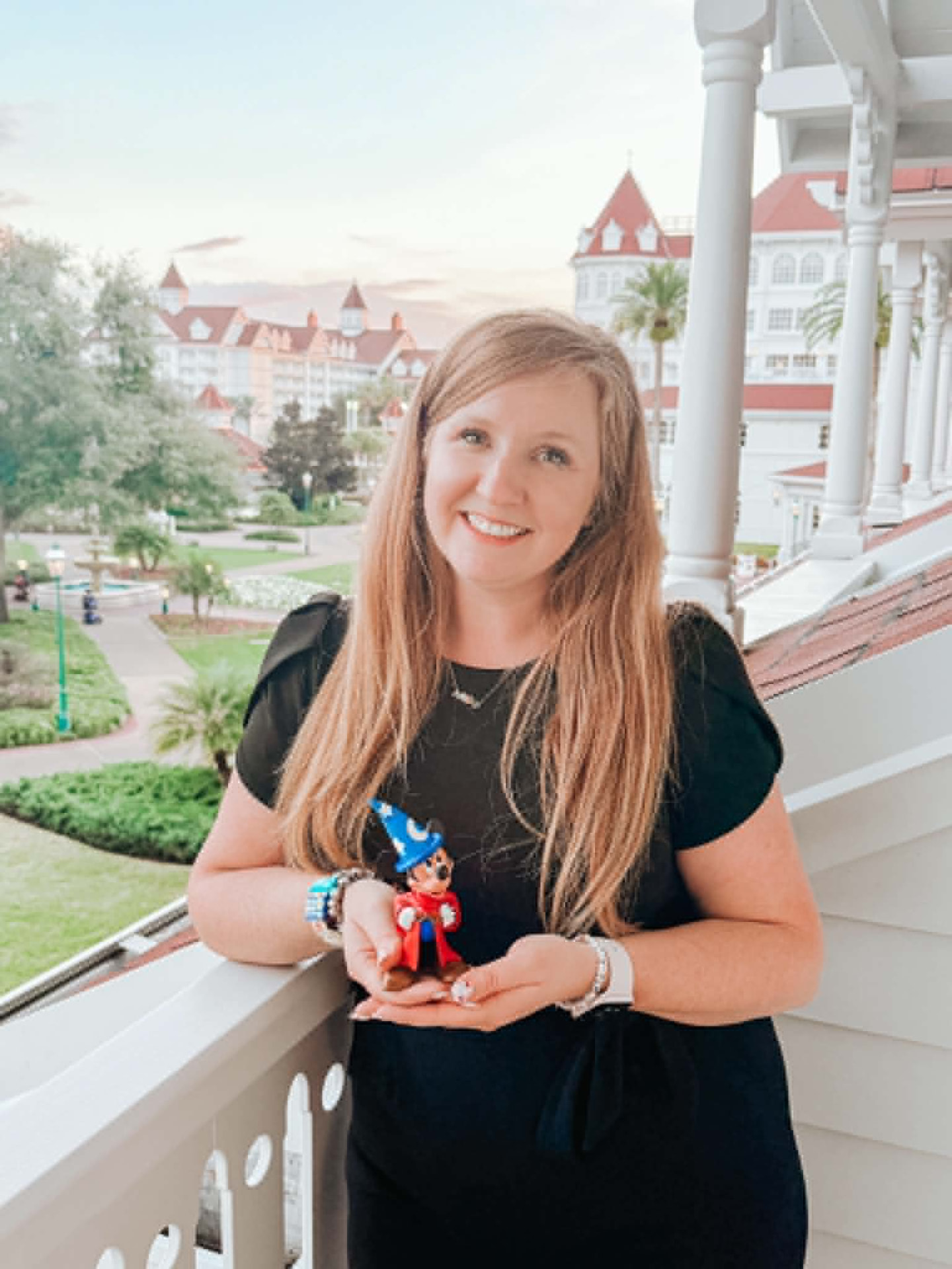 Rebekah Leitner Zigby holding a Sorcerer Mickey figure at Disney's Grand Floridian Resort & Spa