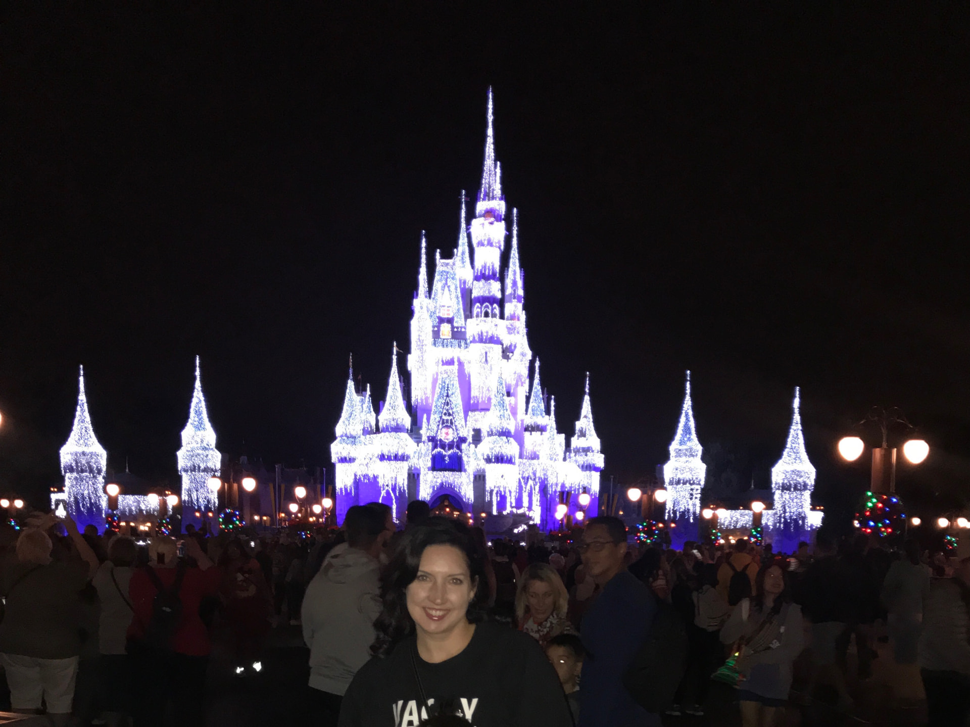 Diana Tombolillo in front of Cinderella Castle illuminated with icicle lights