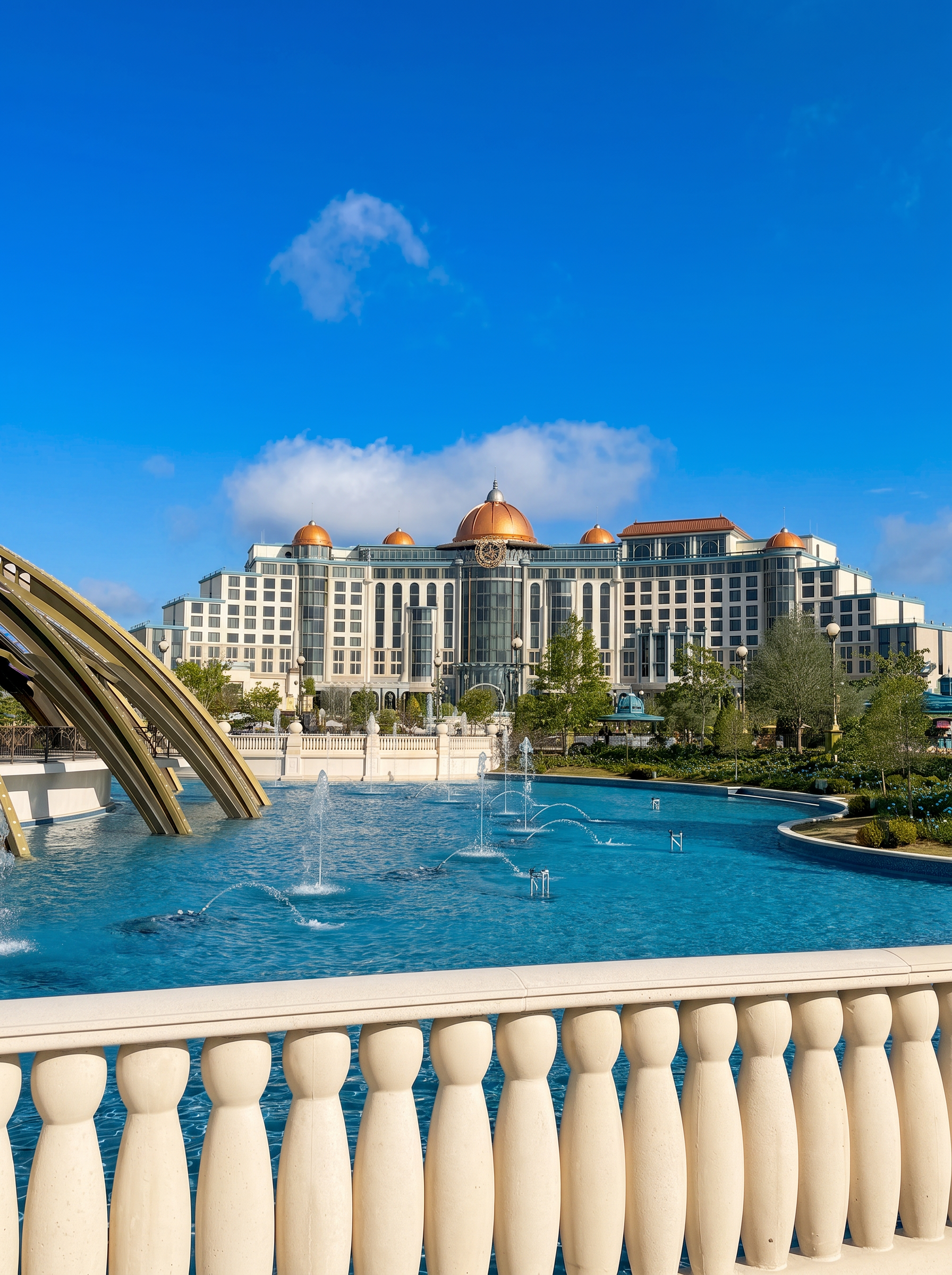 Grand Universal Orlando resort hotel with copper domes and fountain under a bright blue sky