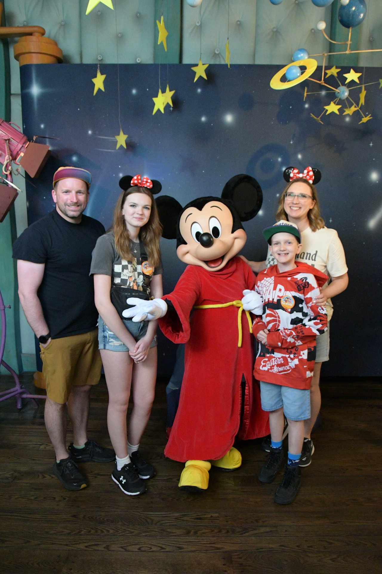 Krystal Moore with her family meeting Sorcerer Mickey