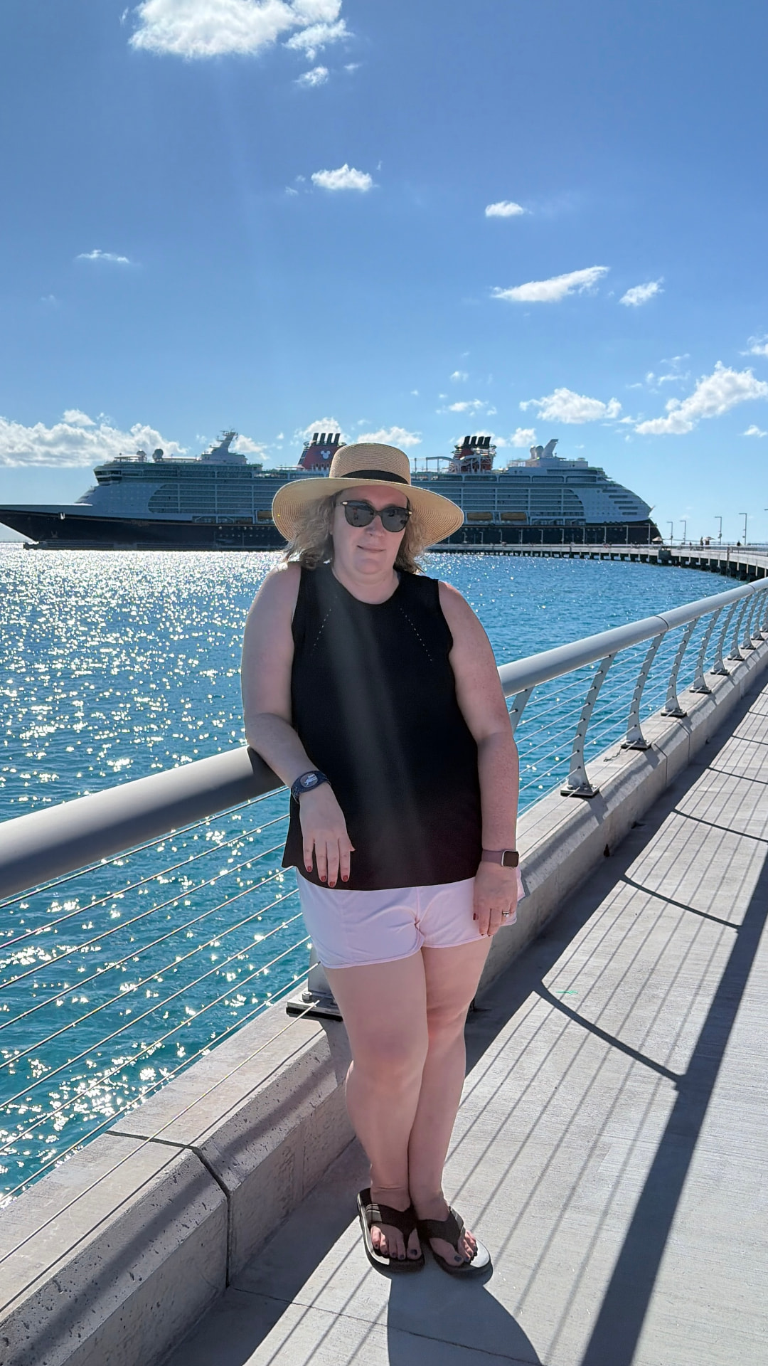 Jade Gambicourt on the pier with a Disney Cruise Line ship behind her