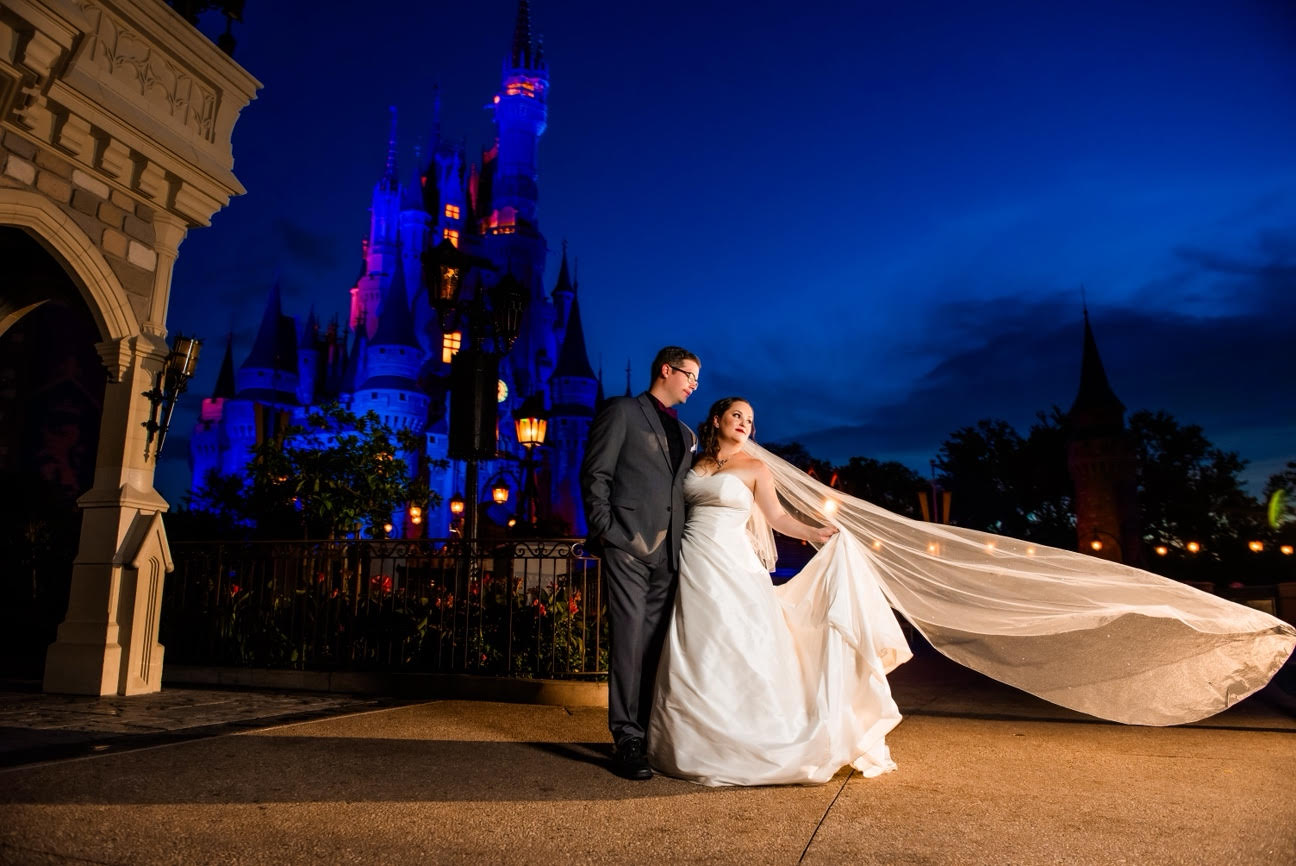 Laura and her husband on their wedding day in front of Cinderella Castle at Magic Kingdom