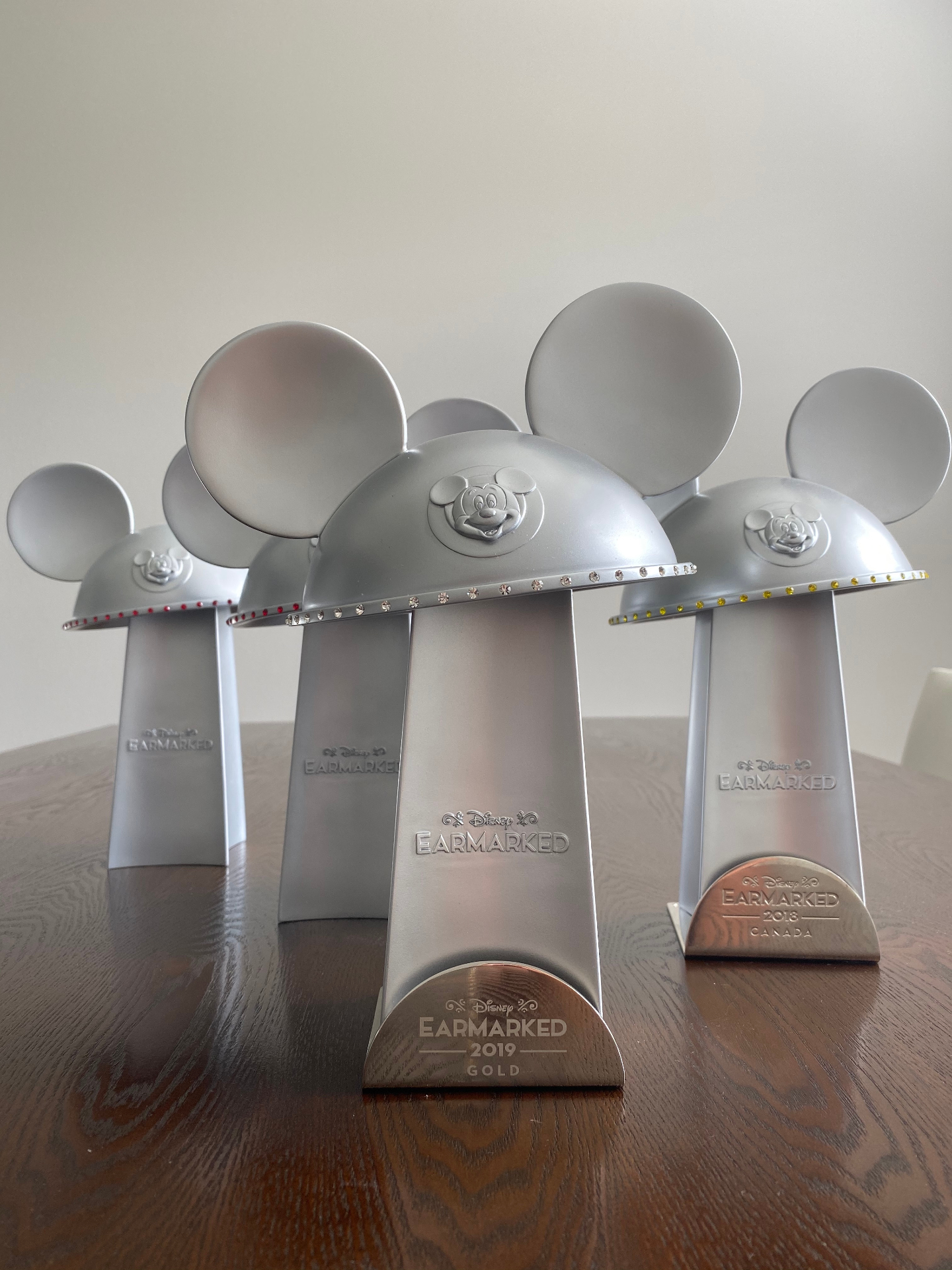 Disney Earmarked Mickey ear hat trophies including 2019 Gold and 2018 Canada