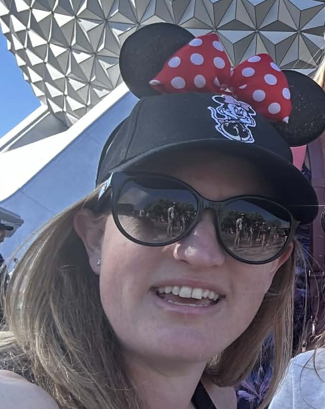 Mandy in Minnie ears in front of Spaceship Earth at Epcot