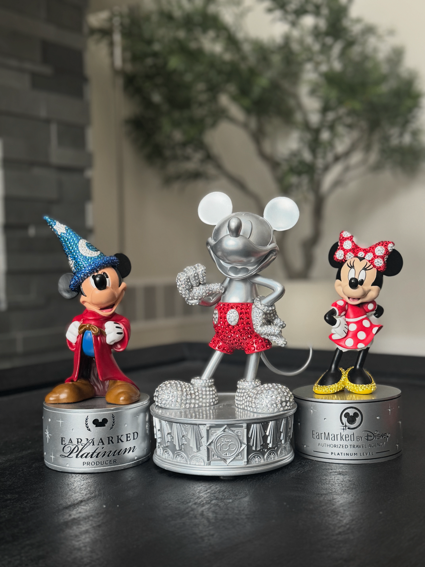 Disney Earmarked Platinum Producer crystal figurine awards on display