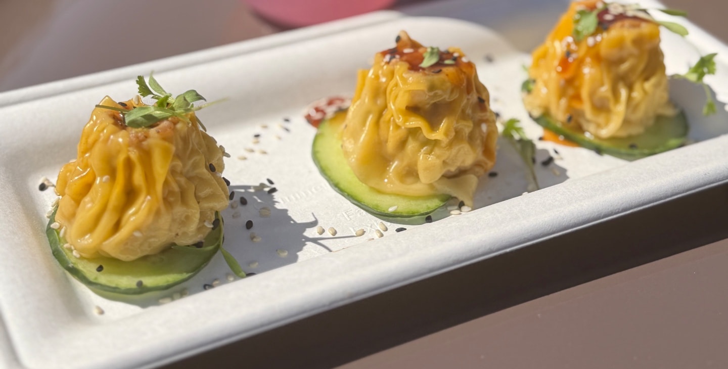 Dumplings and a pink cocktail from an Epcot festival food booth