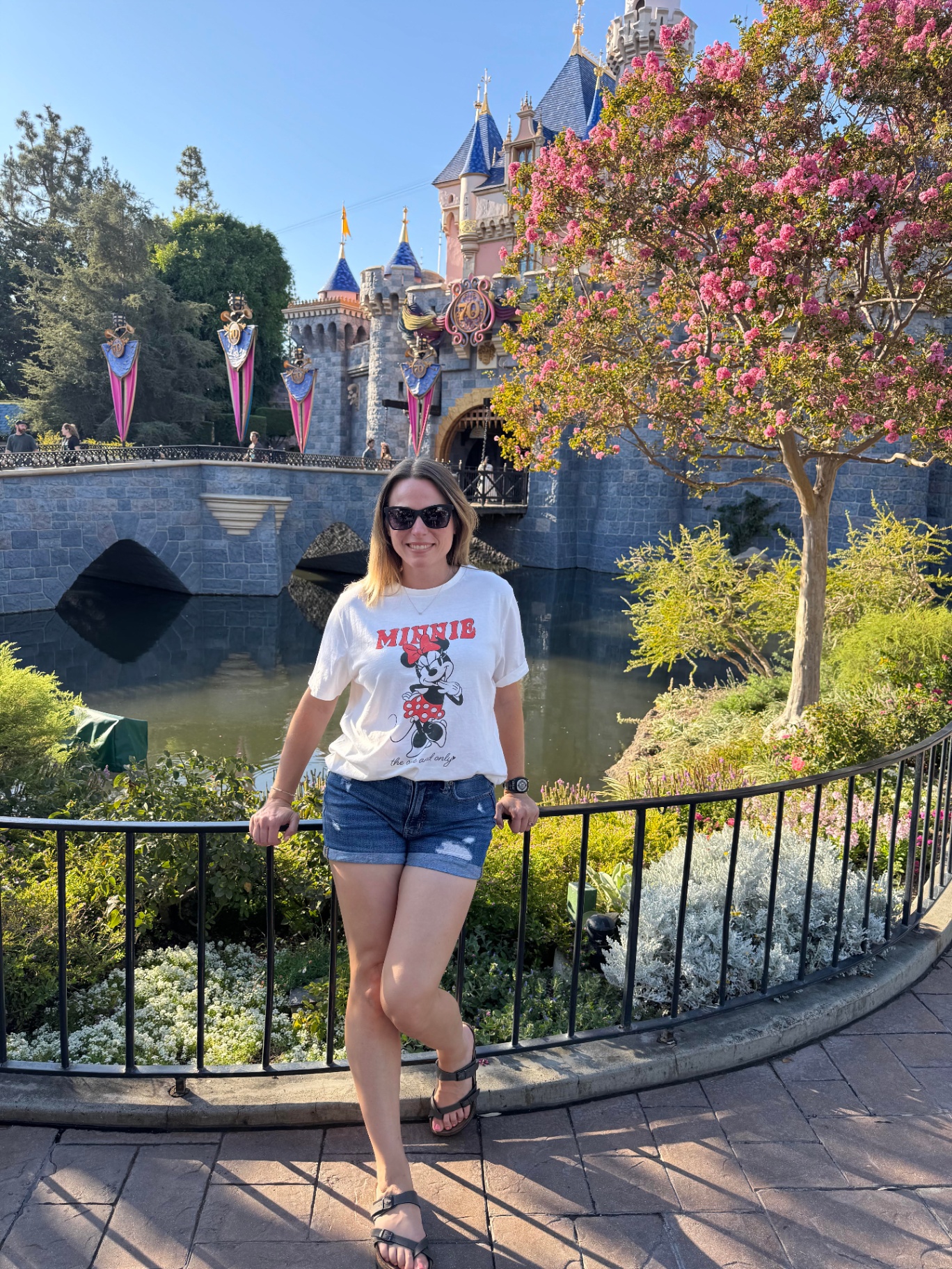 Michelle in front of Sleeping Beauty Castle at Disneyland's 70th anniversary
