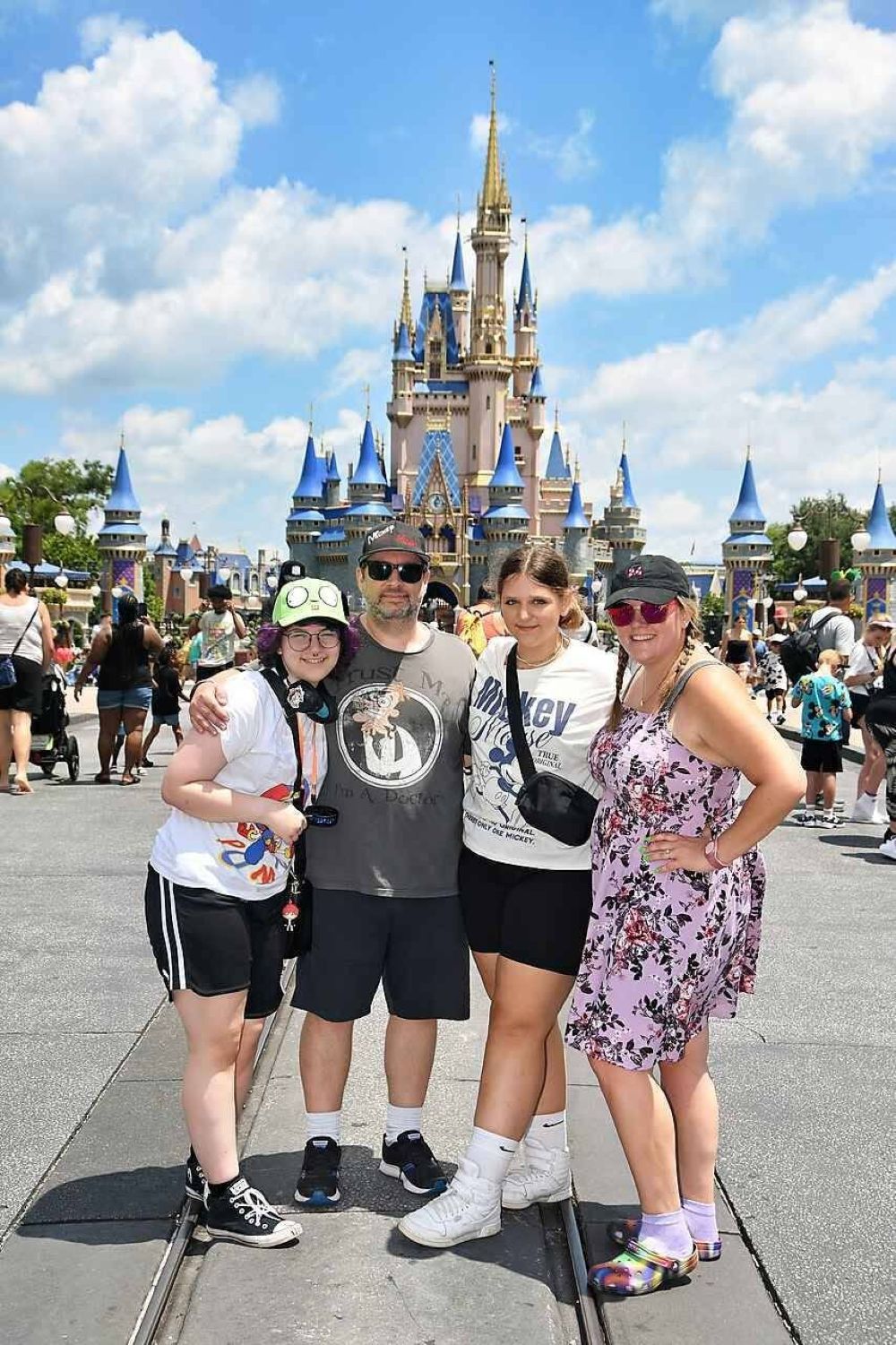 Jen and her family in front of Cinderella Castle at Magic Kingdom