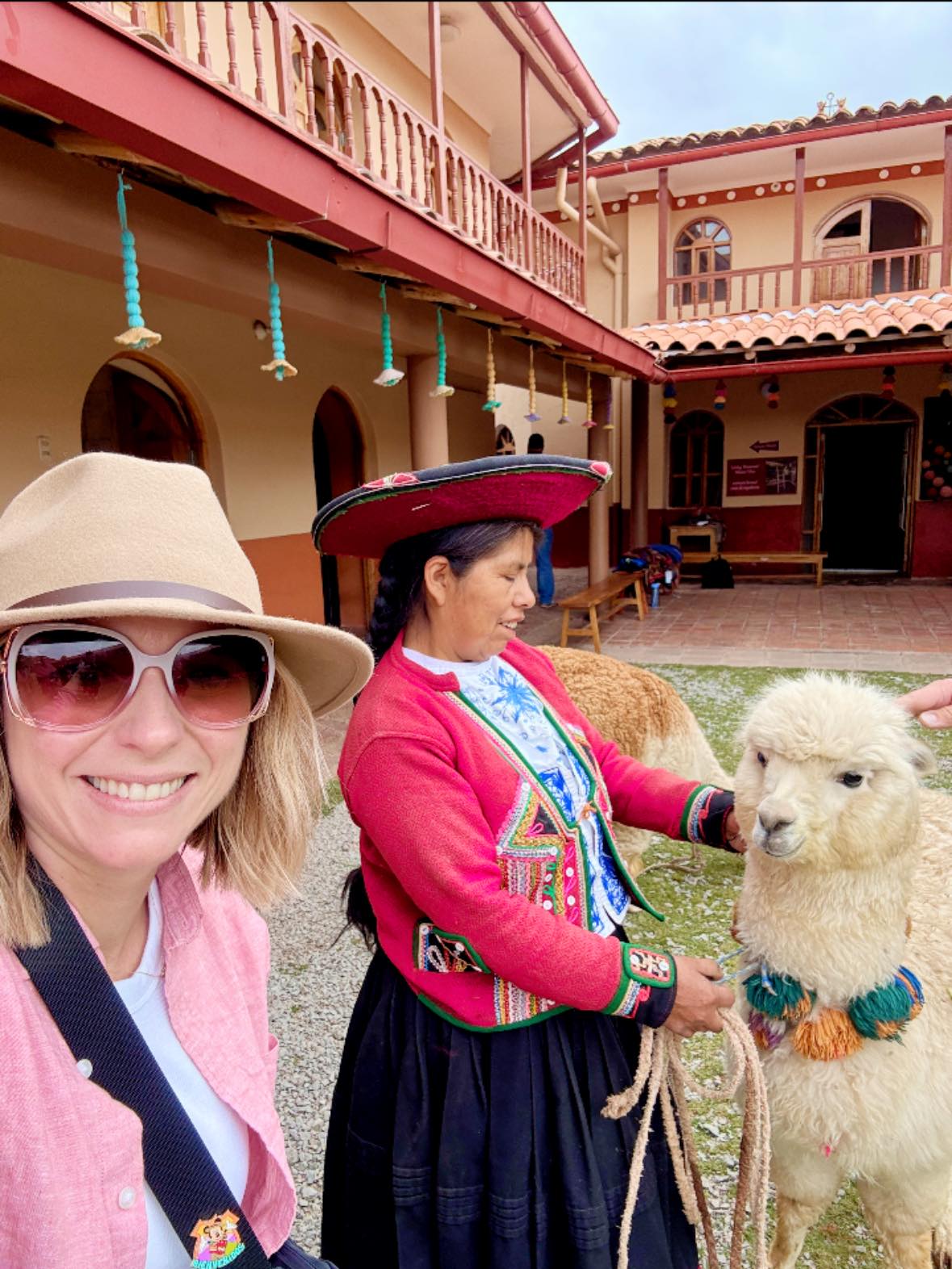 Michelle meeting a Quechua weaver and an alpaca in the Sacred Valley of Peru with Adventures by Disney