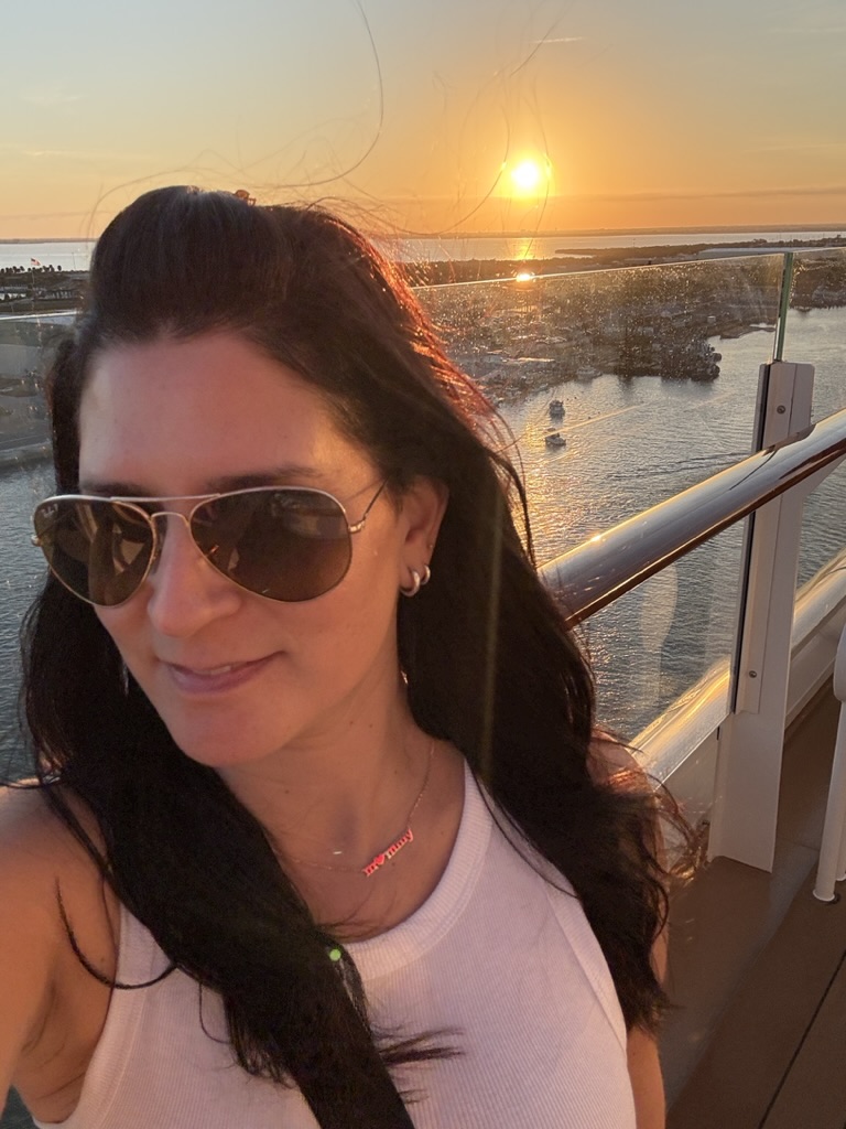 Deborah watching the sunset from the Disney Wish