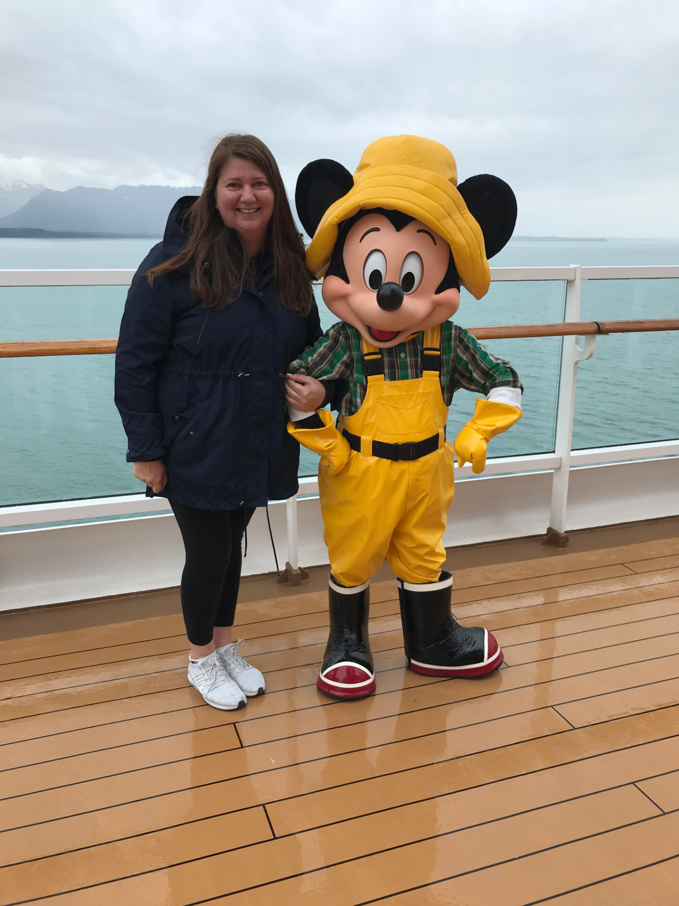 Sandra with Mickey Mouse on deck during an Alaska Disney Cruise